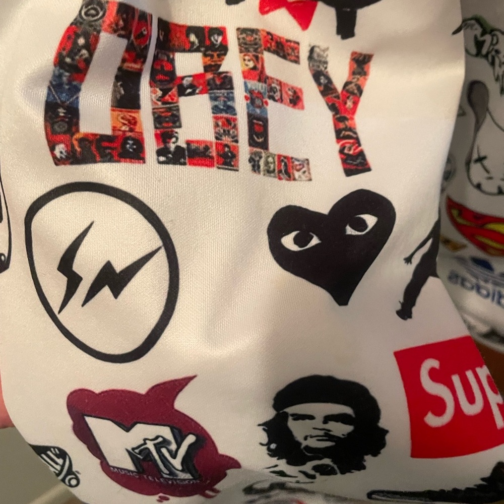 Designer pullover sweatshirt featuring logos from other luxury brands.